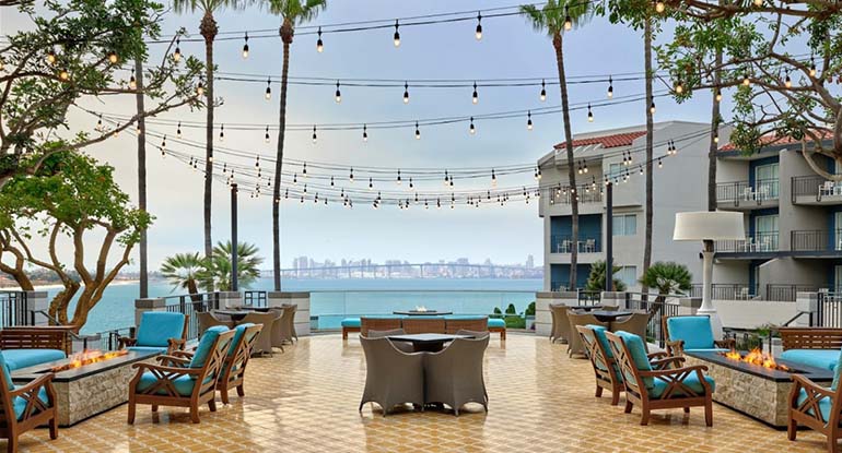 Outdoor patio for dining and entertainment with an ocean view at Loews Coronado Bay Resort