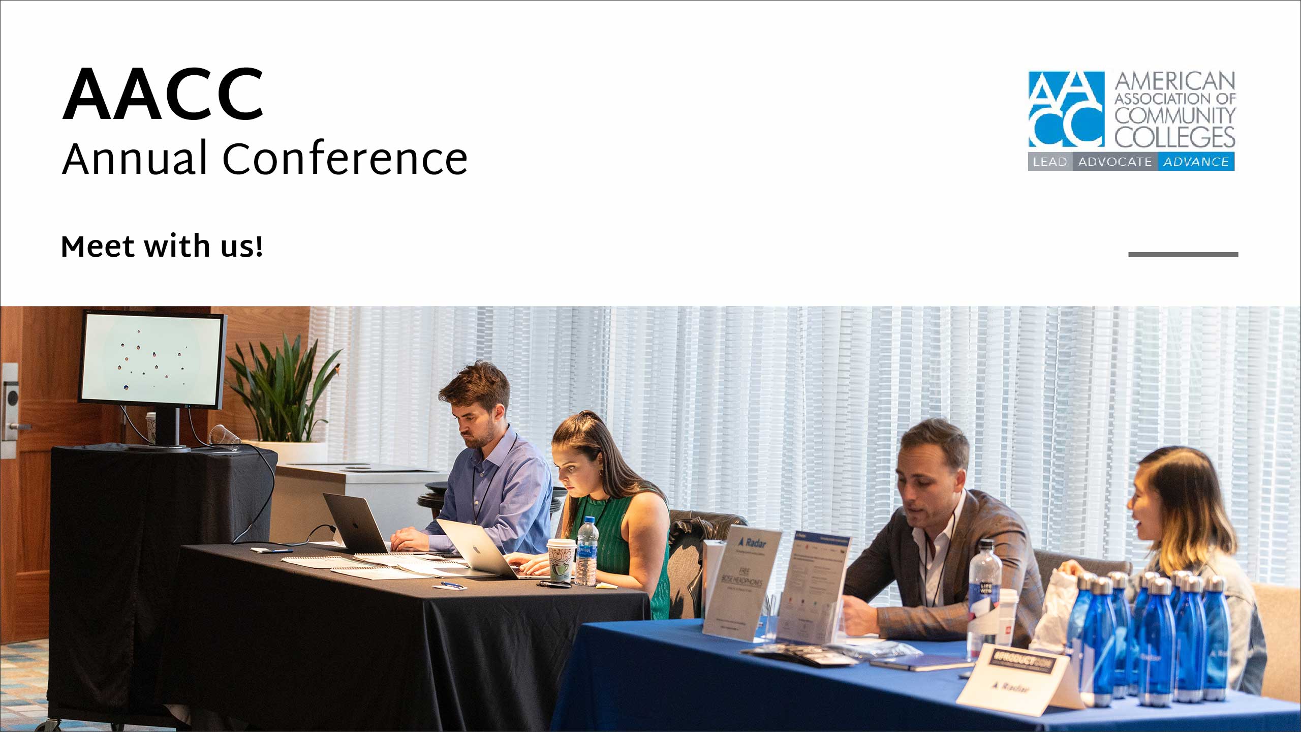 Four trade show attendees at conference tables.