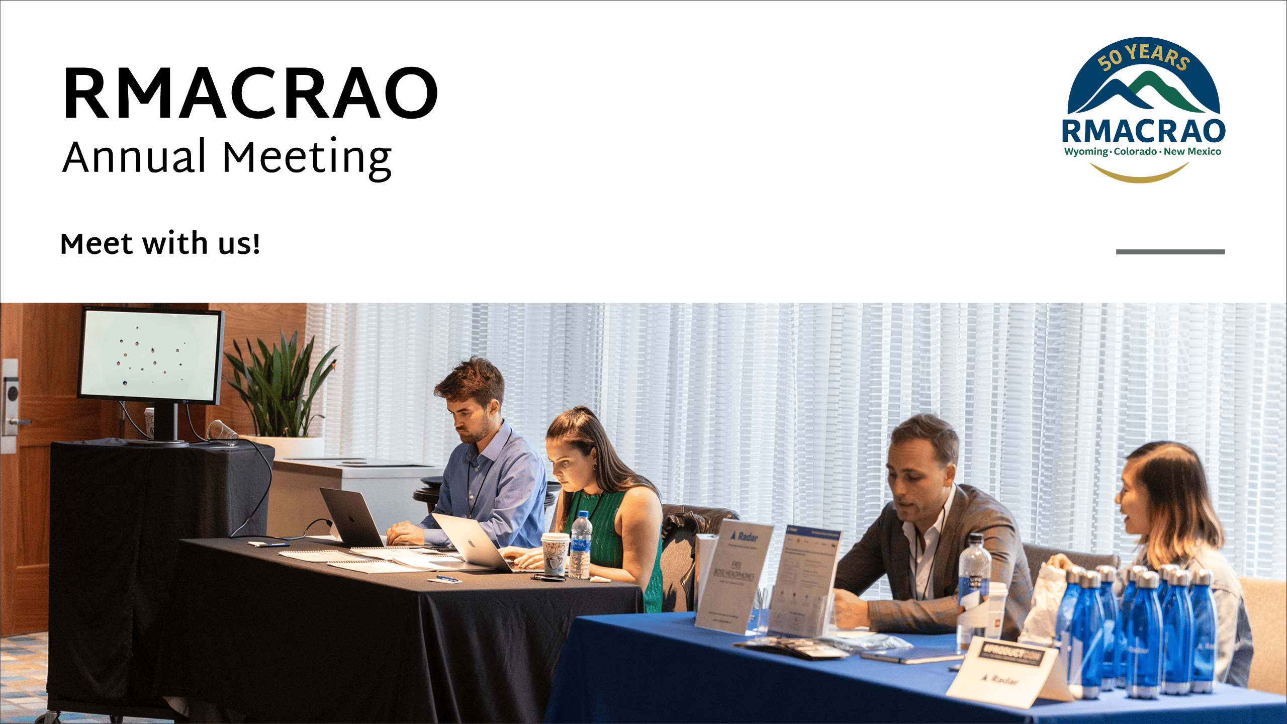 Four trade show attendees at conference tables.